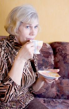 Woman relaxing drinks tea
