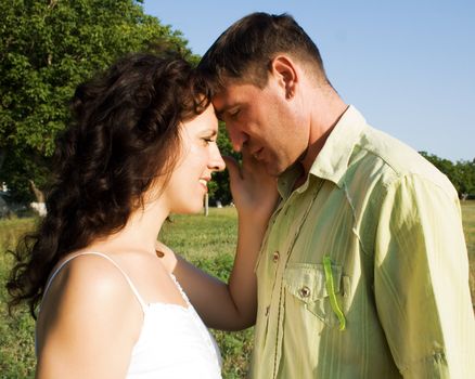 Happy young couple in love hugging in nature 