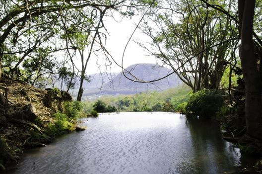 Landscape with calm river, The origin of high waterfall 