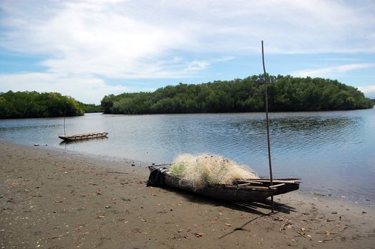 Canoes with fishing net on beach Papua New Guinea