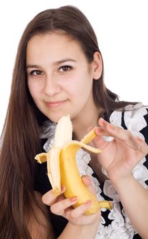 Young beautiful and healthy woman is eating a banana
