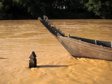 Timber boat at muddy river, Padang Tungku, Malaysia