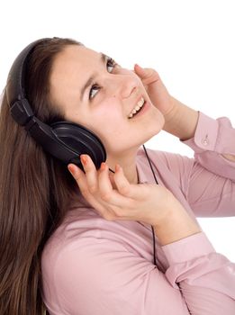 Girl listening to music on headphones. Isolated on white background
