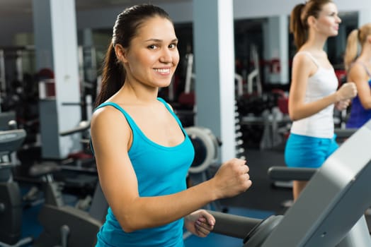 young women running on a treadmill, exercise at the fitness club