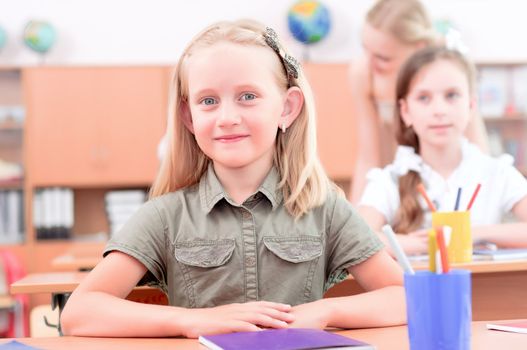 portrait of students in the classroom, sit at school desks