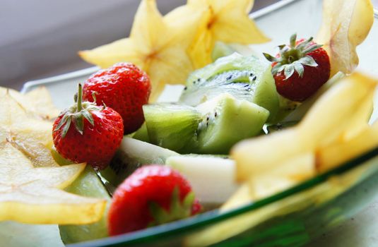 Healthy salad - mix of summer and exotic fruits                  