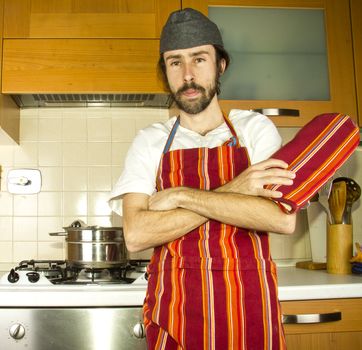 portrait of male chef with wok in the shoulder