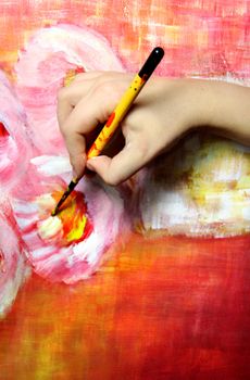 Artist�s hand holding a paintbrush 