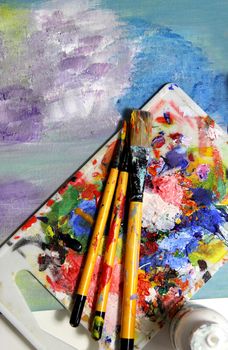 Mixing painting, art palette and paintbrushes 