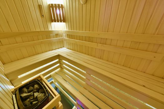 Finnish sauna. Small room with shelves and electric heater stones.