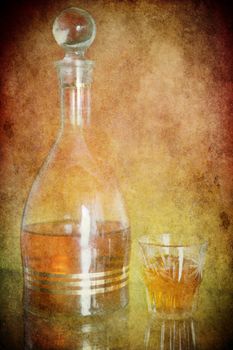 Cognac in a bottle on the old brown paper