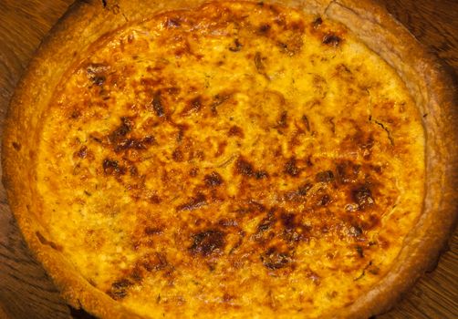 Homemade quiche pie with eggs, cheese,onion closeup