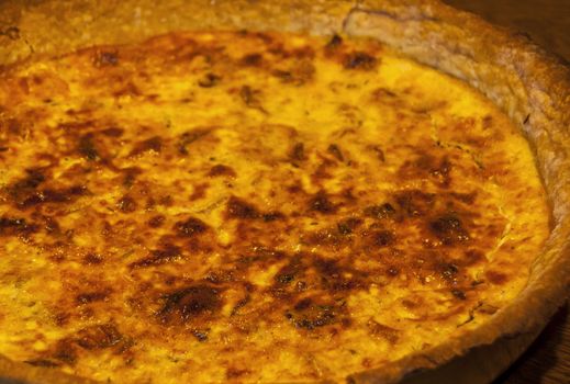 Homemade quiche pie with eggs, cheese,onion closeup