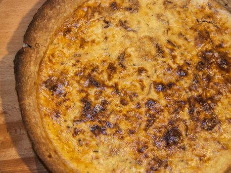 Homemade quiche pie with eggs, cheese,onion closeup