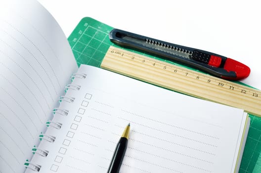 notebook, pen with stationeries or office supplies