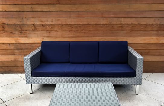 Image on a patio of a contemporary blue and silver outdoor couch
