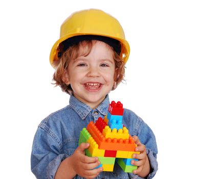 Beauty little girl with yellow helmet and toy block