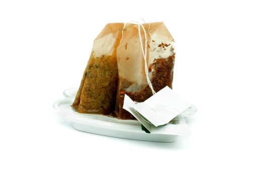 Two Used Teabags on White Teabag's Table Stands isolated on white background