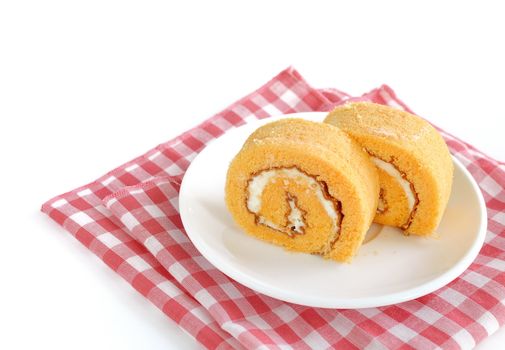 roll cake with cream on white