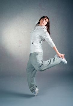 modern style dancer posing on  gray background 