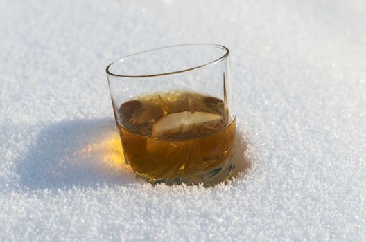 whiskey on the rocks in winter snow