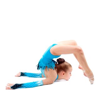 little girl makes gymnastic over white background 