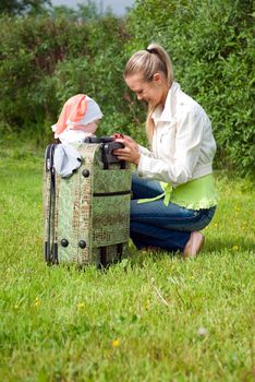 girl and child in valise.family goes to journey