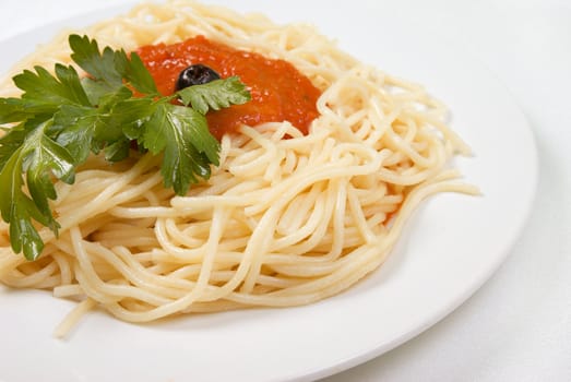 Spaghetti with tomato sauce and parsley.Italian kitchen