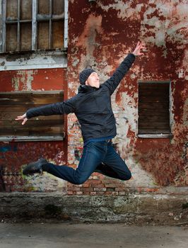 cool looking dancer posing on a grunge background with graffiti 