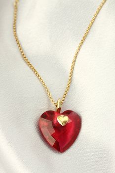 red gemstone crystal , shape of a heart 