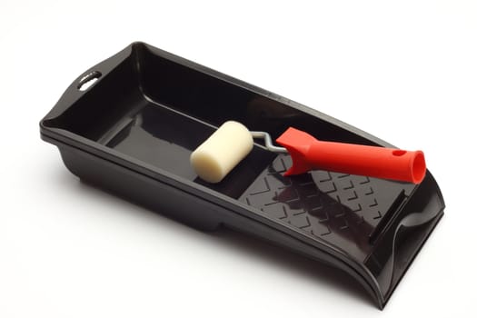Roller brush and tray close up on white
