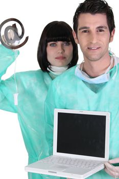 medical workers holding a laptop and an at sign