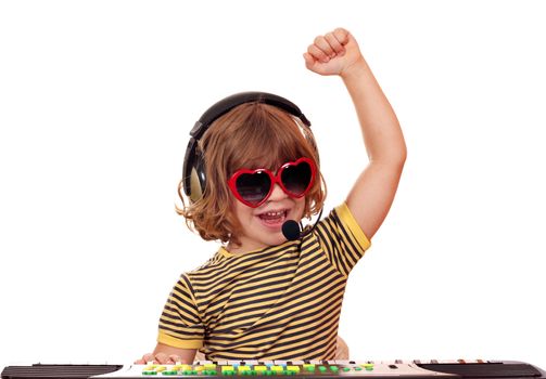 happy little girl play music on keyboard