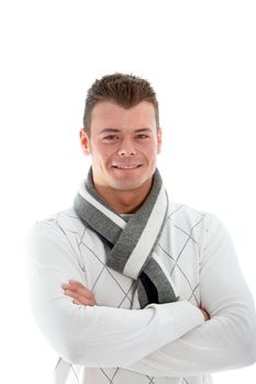 Smiling confident good-looking young man in a scarf standing with his arms folded across his chest isolated on white