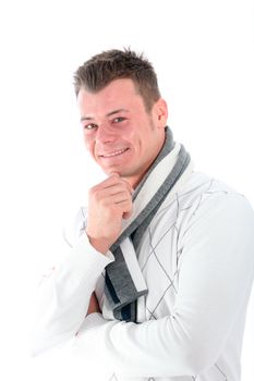Pensive good-looking young man smiling in pleasure as he looks sideways at the camera with his hand to his chin isolated on white