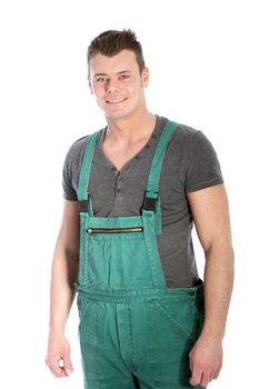 Strong fit handsome young man in dungarees standing looking at the camera with a confident smile isolated on white