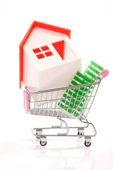 House on shopping cart over white 