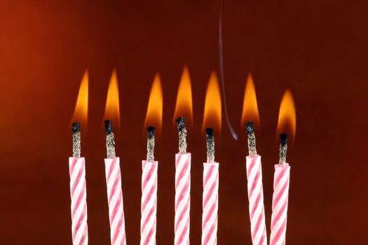 Some lit birthday candles close up 