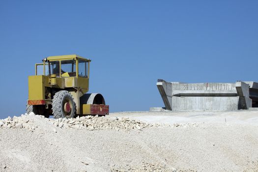 Road roller working at road construction site