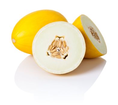 Two honeydew melons on white background. One sliced in half, second whole