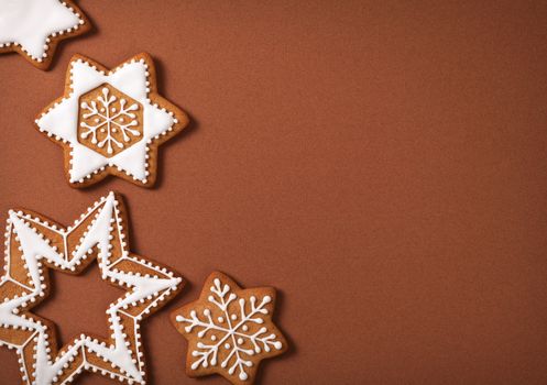 Christmas gingerbread stars on brown paper background. Top view