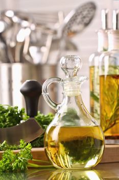 Bottle of olive oil and fresh chopped parsley 