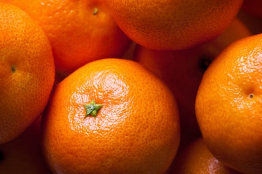 Heap of fresh mandarin oranges, close-up shot as background