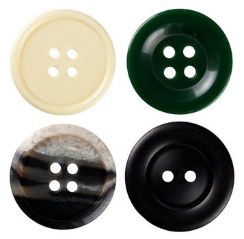 Four varied sewing buttons isolated on white background. Each one is shot seperately