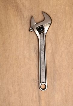 Metal spanner isolated on a wooden table