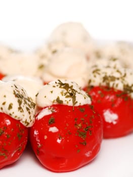 Tomato with cream cheese and basil isolated on white background