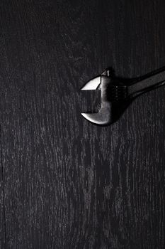 Metal spanner isolated on a wooden table