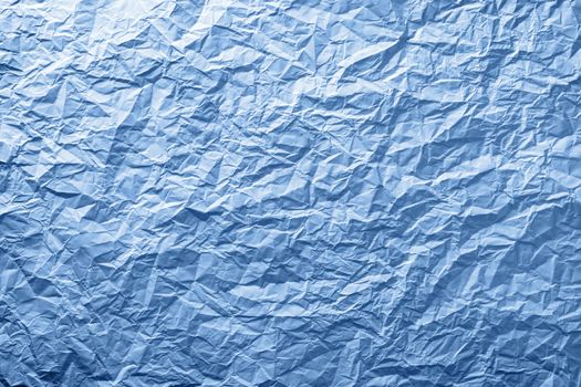 Blue crumpled paper texture for background. Top view