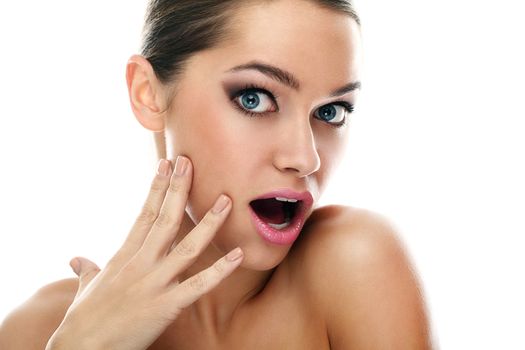 Young beautiful latino woman surprised over white background