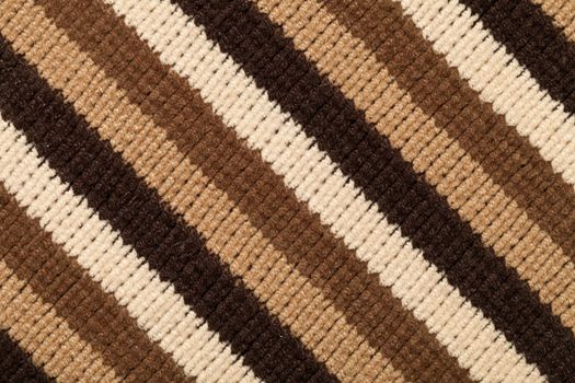 Knitted fabric texture for background. Brown stripes, closeup